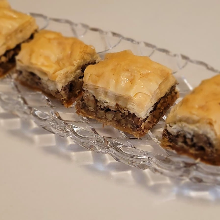 Baklava squares — golden layered phyllo pastry with walnut filling, glistening with syrup